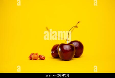 ripe cherries with pits are isolated against the background. Stock Photo