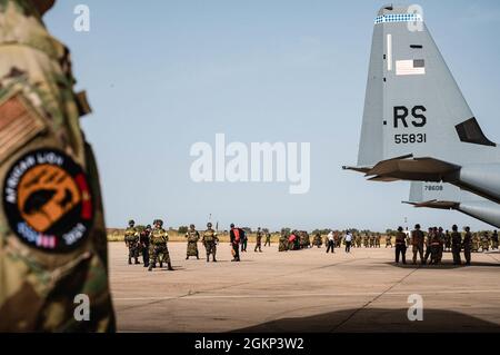 Royal Moroccan Air Force paratroopers prepare to load onto three