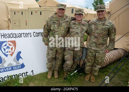 Indiana National Guard Sgt. Wolgan Ramos, Sgt. Margaret Bui and Master Sgt. Brandon Wood pose for a photo representing #MySquad at the 38th Sustainment Brigade tactical operations center at Camp Atterbury, Thursday, June 10, 2021. The brigade soldiers from Marion, Logansport and Indianapolis respectively participated in a warfighter exercise, which tests soldiers in virtual battlefield scenarios so that they can coordinate and communicate in functional tasks such as command and control, movement and maneuver, intelligence, targeting processes, sustainment and protection. Stock Photo