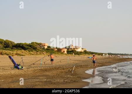 Fishing pole on the sandy beach, early dawn, sunrise, morning over  Mediterranean sea Stock Photo - Alamy