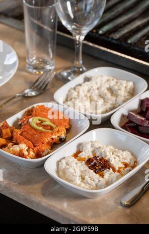 Different types of meat grilled on Barbecue on the table, Served with special Turkish appetizers and Turkish raki. Stock Photo