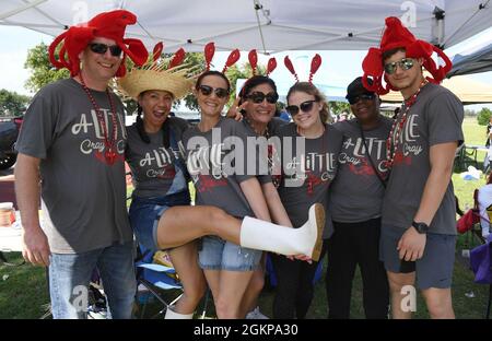Members of the 81st Training Wing wing staff agency team, "A Little Cray Cray," pose for a photo during the 9th Annual Crawfish Cook-Off at the Bay Breeze Event Center at Keesler Air Force Base, Mississippi, June 11, 2021. Twelve teams competed in the event and more than 800 pounds of crawfish were distributed. Stock Photo