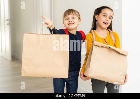 advertising, childhood, delivery, mail and people - two little girls with delivery packages Stock Photo