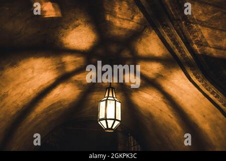 light from the lamp and the shadows in the mysterious corridor in old dungeon Stock Photo