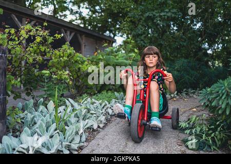 Little girl riding a bike in the park Stock Photo