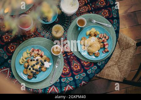 Breakfast with pancakes and fruit on the table Stock Photo