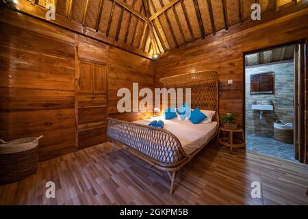Nice warm interior of mountain wooden lodge bedroom Stock Photo