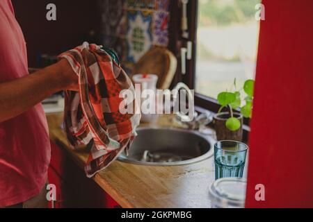 Man washing dishes at home Stock Photo