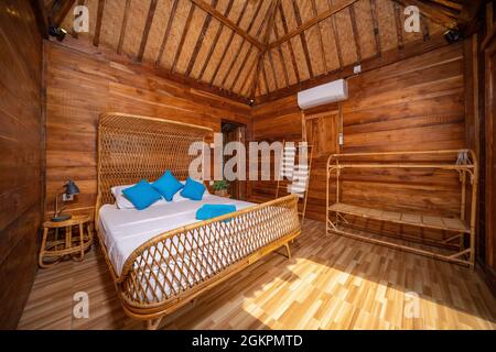 Nice warm interior of mountain wooden lodge bedroom Stock Photo