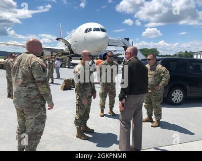 Maj. Gen. Mark Schindler, second from right, acting adjutant general of Pennsylvania, and Command Sgt. Maj. Jon Worley, far right, senior enlisted leader, Pennsylvania National Guard, talk with Soldiers from 1st Squadron, 104th Cavalry Regiment, 2nd Infantry Brigade Combat Team at Harrisburg International Airport in Middletown, Pa., on June 15, 2021. More than 200 Soldiers from 1-104th Cav. departed June 15 for a deployment to the Middle East. They will first travel to Fort Bliss, Texas, for pre-deployment training.