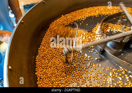 The roasted corn kernels cool as they are constantly moved. Circolo d'Onsernone, Switzerland