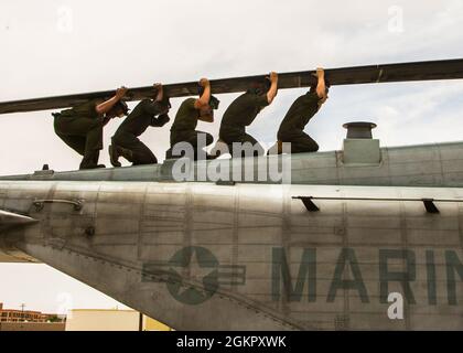 U.S. Marine Corps CH-53E aircraft maintainers attached to Marine Heavy Helicopter Squadron (HMH) 361, Marine Aircraft Group 16, 3rd Marine Aircraft Wing, perform routine maintenance at Naval Air Station Fallon, Nevada, June 16, 2021. Maintainers are essential in 24/7 mission readiness because they preserve and improve the reliability, safety, and lethality of Marine Corps Aviation with their attention to detail and  timely requests. Stock Photo