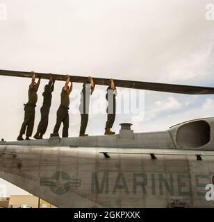 U.S. Marine Corps CH-53E aircraft maintainers attached to Marine Heavy Helicopter Squadron (HMH) 361, Marine Aircraft Group 16, 3rd Marine Aircraft Wing, perform routine maintenance at Naval Air Station Fallon, Nevada, June 16, 2021. Maintainers are essential in 24/7 mission readiness because they preserve and improve the reliability, safety, and lethality of Marine Corps Aviation with their attention to detail and  timely requests. Stock Photo
