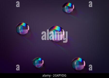 Close up of colorful water drops on a CD, DVD Stock Photo