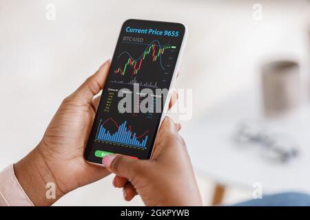 Cropped of black businesswoman buying bitcoins, using mobile app Stock Photo