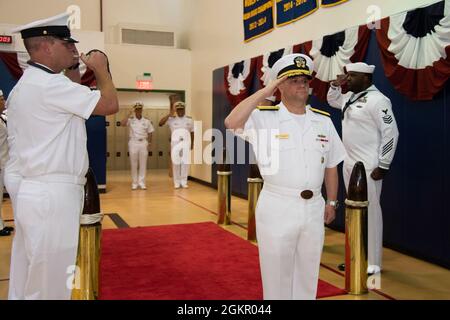 AGANA HEIGHTS, Guam (June 16, 2021) - Rear Adm. Benjamin Nicholson is piped aboard during a change of command ceremony at Guam High School. Nicholson relieved Rear Adm. John Menoni as commander, Joint Region Marianas. Stock Photo