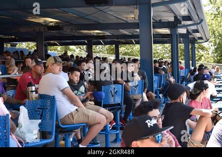 U.S. Navy Sailors and family enjoy a buffet during a Norfolk Tides baseball game at Harbor Park, for a Morale, Welfare and Recreation sponsored event, in Norfolk, Virginia, June 17, 2021. The John C. Stennis (CVN 74) is in Newport News Shipyard working alongside NNS, NAVSEA and contractors conducting Refueling and Complex Overhaul as part of the mission to deliver the warship back in the fight, on time and on budget, to resume its duty of defending the United States. Stock Photo