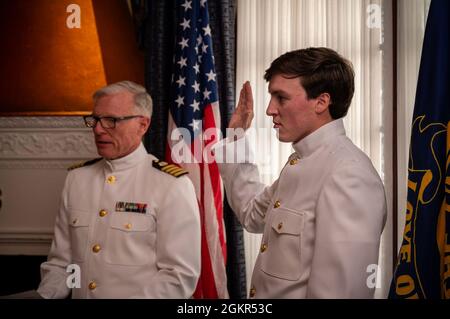 210617-N-WF272-1056 PHILADELPHIA (June 17, 2021) William Pinamont III, right, from West Chester, Pa., is commissioned by his father, retired Navy Capt. William Pinamont Jr., as an Ensign during a commissioning ceremony held at the Union League of Philadelphia. Pinamont commissioned through the Navy Health Professions Scholarship Program, and will serve as a doctor in the U.S. Navy Medical Corps upon graduating from Penn State College of Medicine. Stock Photo