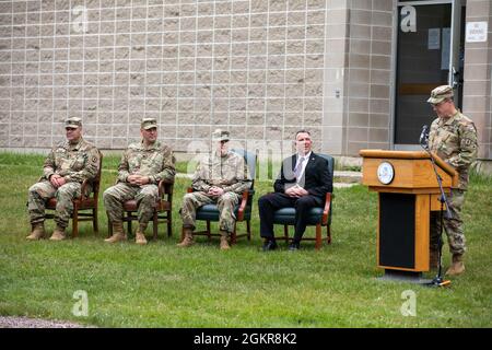 U.S. Army Sgt. 1st Class Dustin Dearborn of the Army Mountain Warfare School, 124th Regional Training Institute, Vermont Army National Guard, is awarded the Soldier Medal for heroism by Vermont State Governor Phil Scott at Camp Ethan Allen Training Site, Jericho, Vermont, Jun. 18, 2021. Sergeant Dearborn and his team operated a night rescue mission in frigid winter temperatures to save the life of a downed skier. Stock Photo