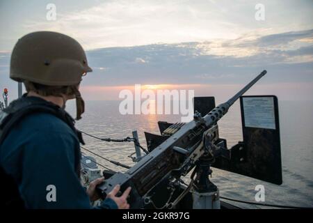 Eckernforde, Germany (June 19, 2021) Sonar Technician 3rd Class Nathaniel Ford mans a .50 caliber machine gun during a sea and anchor evolution aboard the Arleigh Burke-class guided-missile destroyer USS Roosevelt (DDG 80), June 19, 2021. Roosevelt, forward-deployed to Rota, Spain, is on its second patrol in the U.S. Sixth Fleet area of operations in support of regional allies and partners and U.S. national security interests in Europe and Africa. Stock Photo