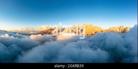 Aerial view of Popera group, Cima Undici and Croda Rossa di Sesto rock peaks emerging from clouds, Dolomites, South Tyrol, Italy, Europe Stock Photo