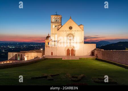 Facade of Basilica di San Francesco d'Assisi, UNESCO World Heritage Site, and gardens at dusk, Assisi, Perugia province, Umbria, Italy, Europe Stock Photo