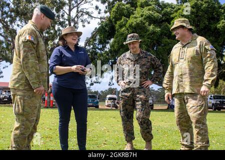 From left to right, Australian Army Lt. Col. Daniel Gosling, operations officer for Headquarters Northern Command, Sophie Szylkaski, manager of communities and social performance - Gove Operations with Rio Tinto, U.S. Marine Corps Col. David Banning, commanding officer of Marine Rotational Force - Darwin and Col. Marcus Constable, commanding officer of HQNORCOM, talk during a community day event at Nhulunbuy, NT, Australia, June 18, 2021. U.S. Marines participating in Exercise Darrandarra displayed an MV-22B Osprey, provided fresh fruit and interacted with the local community. U.S. Marine Corp Stock Photo