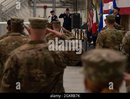 210618-N-UJ449-1132 NAVAL AIR STATION SIGONELLA, Italy (June 18, 2021) Officers and senior enlisted Airmen, assigned to U.S. Air Force 7th Reconnaissance Squadron (7RS), render the first salute to incoming commanding officer, Lt. Col. David Hind during the 7RS change of command ceremony held onboard Naval Air Station (NAS) Sigonella, June 18, 2021. NAS Sigonella’s strategic location enables U.S., allied, and partner nation forces to deploy and respond as required to ensure security and stability in Europe, Africa and Central Command. Stock Photo