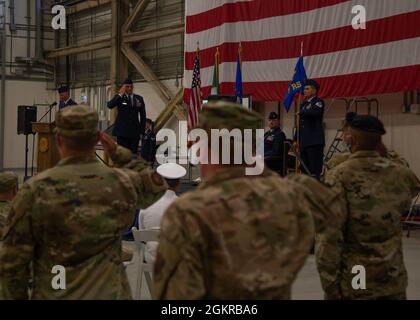 210618-N-UJ449-1087 NAVAL AIR STATION SIGONELLA, Italy (June 18, 2021) Officers and senior enlisted Airmen, assigned to U.S. Air Force 7th Reconnaissance Squadron (7RS), render a final salute to outgoing commanding officer, Lt. Col. Rolly Cooper during the 7RS change of command ceremony held onboard Naval Air Station (NAS) Sigonella, June 18, 2021. NAS Sigonella’s strategic location enables U.S., allied, and partner nation forces to deploy and respond as required to ensure security and stability in Europe, Africa and Central Command. Stock Photo