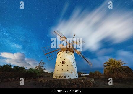 Milky Way glowing over the stone windmill, El Cotillo, La Oliva, Fuerteventura, Canary Islands, Spain, Atlantic, Europe Stock Photo