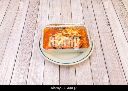 Eggplant and Parmigiana lasagna in aluminum container ready to send home to a starving customer Stock Photo