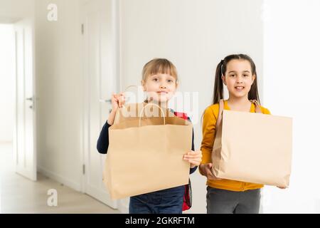 advertising, childhood, delivery, mail and people - two little girls with delivery packages Stock Photo