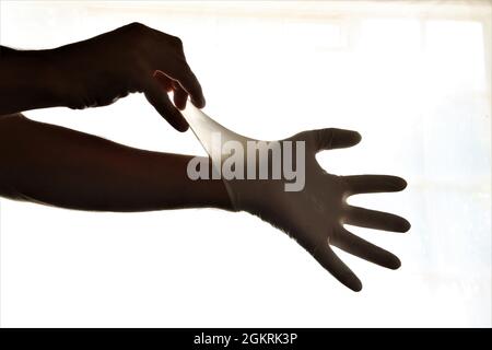 Removing latex gloves from hands.Once gloves have been removed make sure to wash your hands with soap and water. Stock Photo
