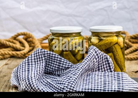 Closeup of glass jars with pickled vegetables - pickled cucumbers Stock Photo