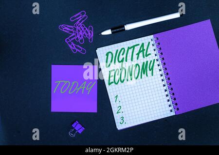 Hand writing sign Digital Economy. Word for economic activities that are based on digital technologies Multiple assorted collection office stationery Stock Photo