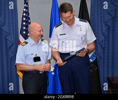 Vice Chief of Space Operations Gen. David Thompson and Lt. Gen. Luca Goretti, vice air chief of the Italian air force, exchange gifts after a meeting at the Pentagon, Arlington, Va., June 23, 2021. Thompson and Goretti discussed bilateral space cooperation between their military services. This image has been altered to obscure security badges. Stock Photo