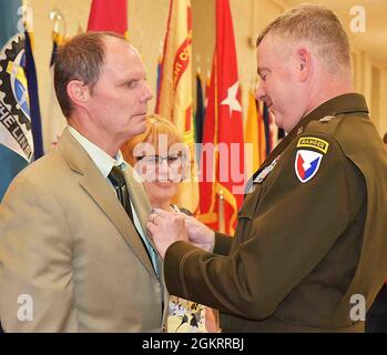 Maj. Gen. Chris Mohan, commanding general, U.S. Army Sustainment Command, and senior mission commander, Rock Island Arsenal, Illinois, awards Michael O’Gara the Civilian Service Achievement Medal during the RIA quarterly retirement ceremony June 23 at Heritage Hall. O’Gara retires with 38 years, with his last position serving as a Joint Munitions Command lead logistics management specialist. Stock Photo