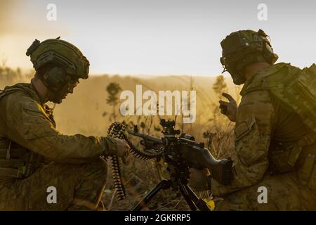 Australian Army soldiers, with 5th Battalion, 5th Royal Australian Regiment, fire a MAG58 general support machine gun while participating in support to ground maneuvers training during Exercise Southern Jackaroo at Mount Bundey Training Area, NT, Australia, June 23, 2021. The training exercised U.S. Marines’, Australian Army soldiers’ and Japan Ground Self-Defense Force soldiers’ combined capabilities to give mounted and dismounted support to small unit ground maneuvers while utilizing multiple weapons systems. Defense ties between the United States, allies and partner nations are critical to Stock Photo