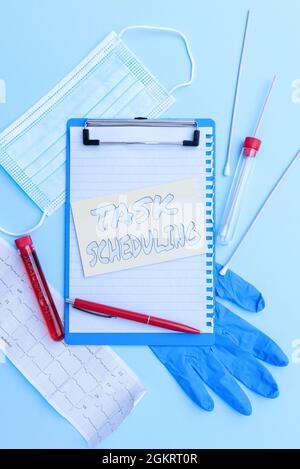 Handwriting text Task Scheduling. Concept meaning The assignment of start and end times to a set of tasks Writing Important Medical Notes Laboratory Stock Photo