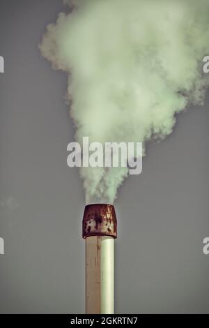Vintage styled image of air pollution from a factory pipe Stock Photo