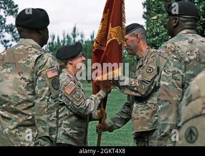 Maj. Gen. Heidi Hoyle, commander, the Military Surface Deployment and Distribution Command passes the brigade colors to Col. Jeremy St. Laurent, commander, 597th Transportation Bde., during a Change of Command Ceremony at Magnolia Park, Fort Eustis, Va. June 25. Stock Photo