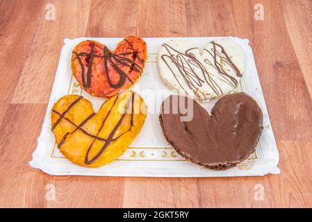 Chocolate, strawberry, sugar and white chocolate palm trees on a tray covered with white paper Stock Photo