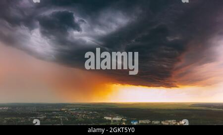 Stormy Sunset Sky Before Rain Above Skyline. Dramatic Cloudy Sky And Flash Light Stock Photo
