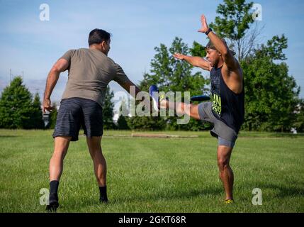 210625-N-WF272-1224 PHILADELPHIA (June 25, 2021) Hospital Corpsman 1st Class David Cooley, a New York native, assigned to Navy Talent Acquisition Group Philadelphia, unsuccessfully blocks a Frisbee toss from Personnel Specialist 1st Class Carlos Garay, a Miami native, during command physical training. NTAG Philadelphia encompasses regions of Pennsylvania, New Jersey, Delaware, Maryland and West Virginia, providing recruiting services from more than 30 talent acquisition sites with the overall goal of attracting the highest quality candidates to ensure the ongoing success of America’s Navy. Stock Photo