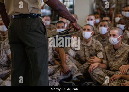 New recruits with Delta Company, 1st Recruit Training Battalion, receive a class during pick up at Marine Corps Recruit Depot, San Diego, June 25, 2021. Recruits were introduced to their drill instructors, and learned their rules and expectations for recruit training. Stock Photo
