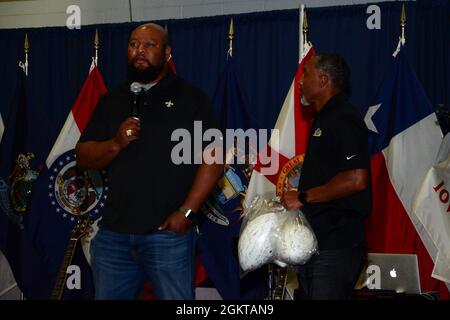 Former New Orleans Saints running back Deuce McAllister (left) speaks to service members during the USO Summer Tour onboard Naval Air Station Stock Photo