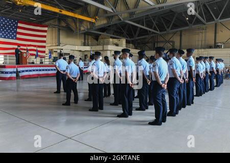 Airmen stand in formation while being addressed by Lt. Gen. Timothy Haugh, 16th Air Force commander, during the 319th Reconnaissance Wing change of command ceremony at Grand Forks Air Force Base, N.D., June 28, 2021. During the ceremony, Col. Cameron Pringle relinquished command to Col. Timothy Curry, former vice commander. Stock Photo