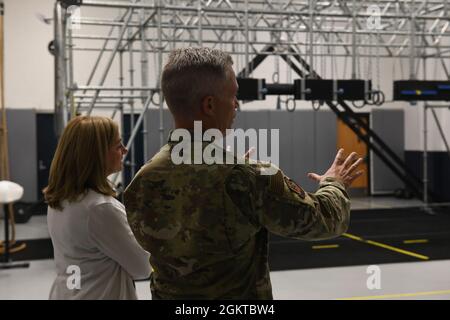 Lt. Gen. Timothy Haugh, 16th Air Force commander, stands with his wife Sherie Haugh while touring the fitness center at Grand Forks Air Force Base, N.D., June 28, 2021. Haugh visited Grand Forks AFB to tour the installation, interact with airmen and leadership, and participate in the 319th Reconnaissance Wing change of command ceremony. Stock Photo