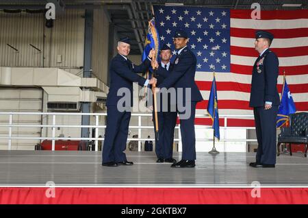 Lt. Gen. Timothy Haugh, 16th Air Force commander, passes the guidon to Col. Timothy Curry, 319th Reconnaissance Wing incoming commander, during the 319 RW change of command ceremony at Grand Forks Air Force Base, N.D., June 28, 2021. The 319 RW is based out of Grand Forks AFB and provides global Intelligence, Surveillance and Reconnaissance (ISR) capability. Stock Photo