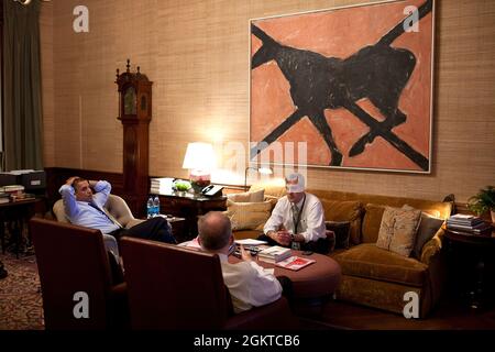 March 16, 2011'The President meets with national security aides John Brennan, foreground, and Denis McDonough after talking on the phone with Prime Minister Naoto Kan of Japan a few days after the devastating earthquake and tsunami in Japan. The call was made near midnight from the Treaty Room office in the White House Residence. Most nights after dinner and time with his family, the President retreats to this office where he catches up on paperwork and reads his briefing material for the next day.'  (Official White House Photo by Pete Souza) Stock Photo